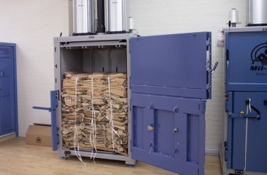 Baled cardboard inside a baler